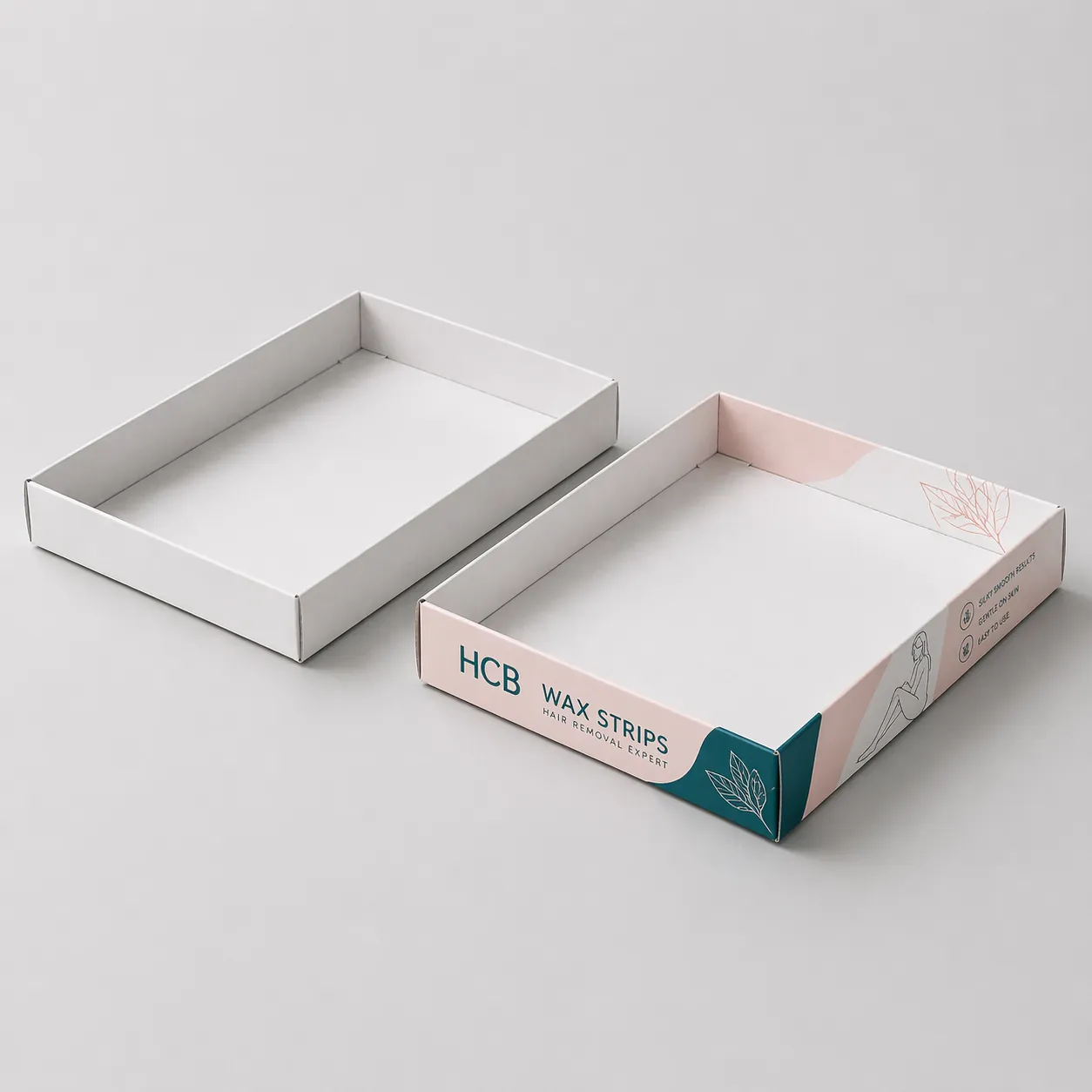 A plain white display tray standing next to a pink floral branded tray for wax strips. class=